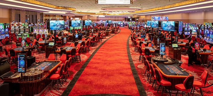 Busy casino with games and slot machines.