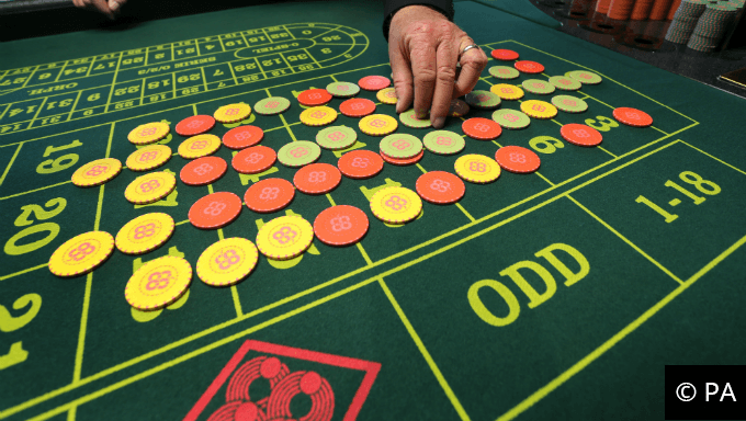 Casino chips on a roulette table.