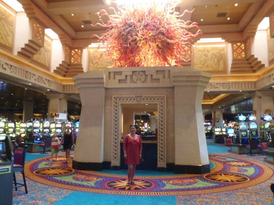 Casino interior with colorful decor and figures.