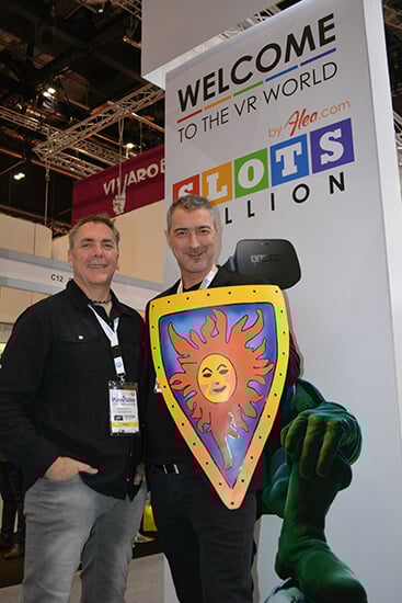 Two men posing with a colorful shield.